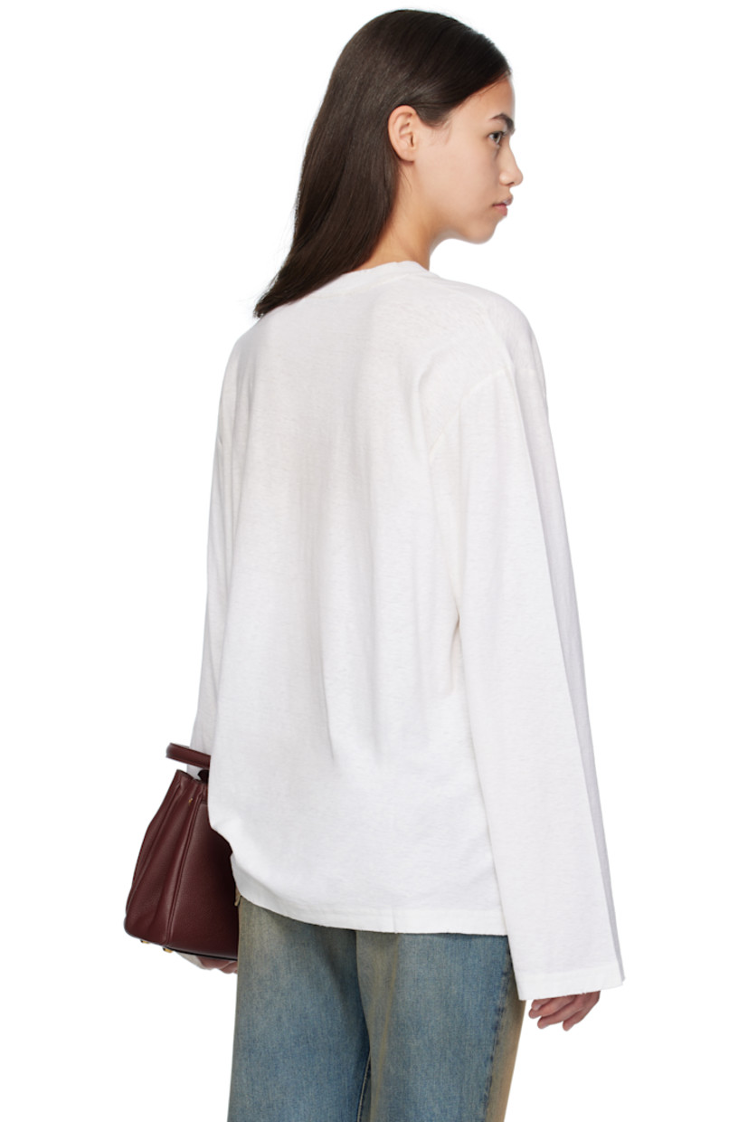 Organic cotton- and True hemp-blend jersey T-shirt.

· Sprayed dye throughout
· Subtle distressing at rib-knit crewneck, hem, and cuffs
· Dropped shoulders
· Logo and text printed at front

Supplier color: Dusty White