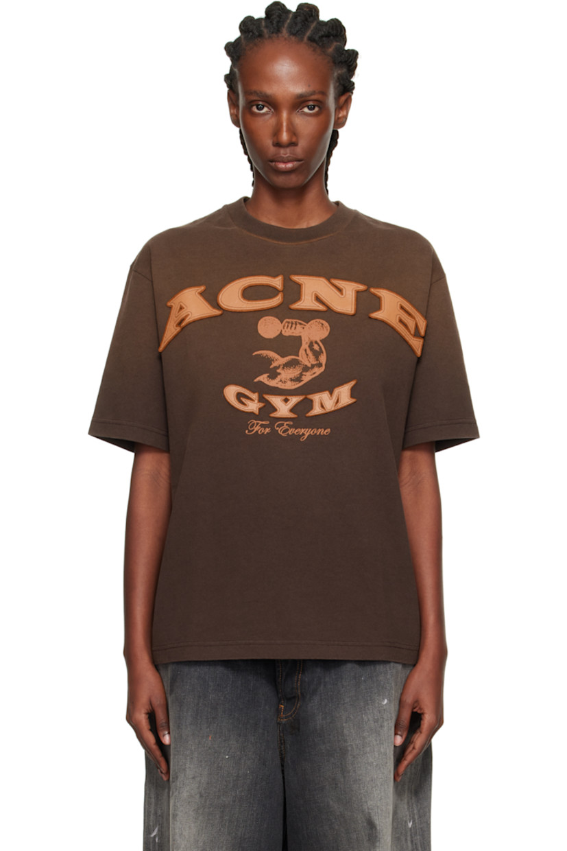 Organic cotton jersey T-shirt.

· Fading throughout
· Rib-knit crewneck
· Logo and text appliqué at front
· Graphic and text printed at front
· Dropped shoulders

Supplier color: Dark brown