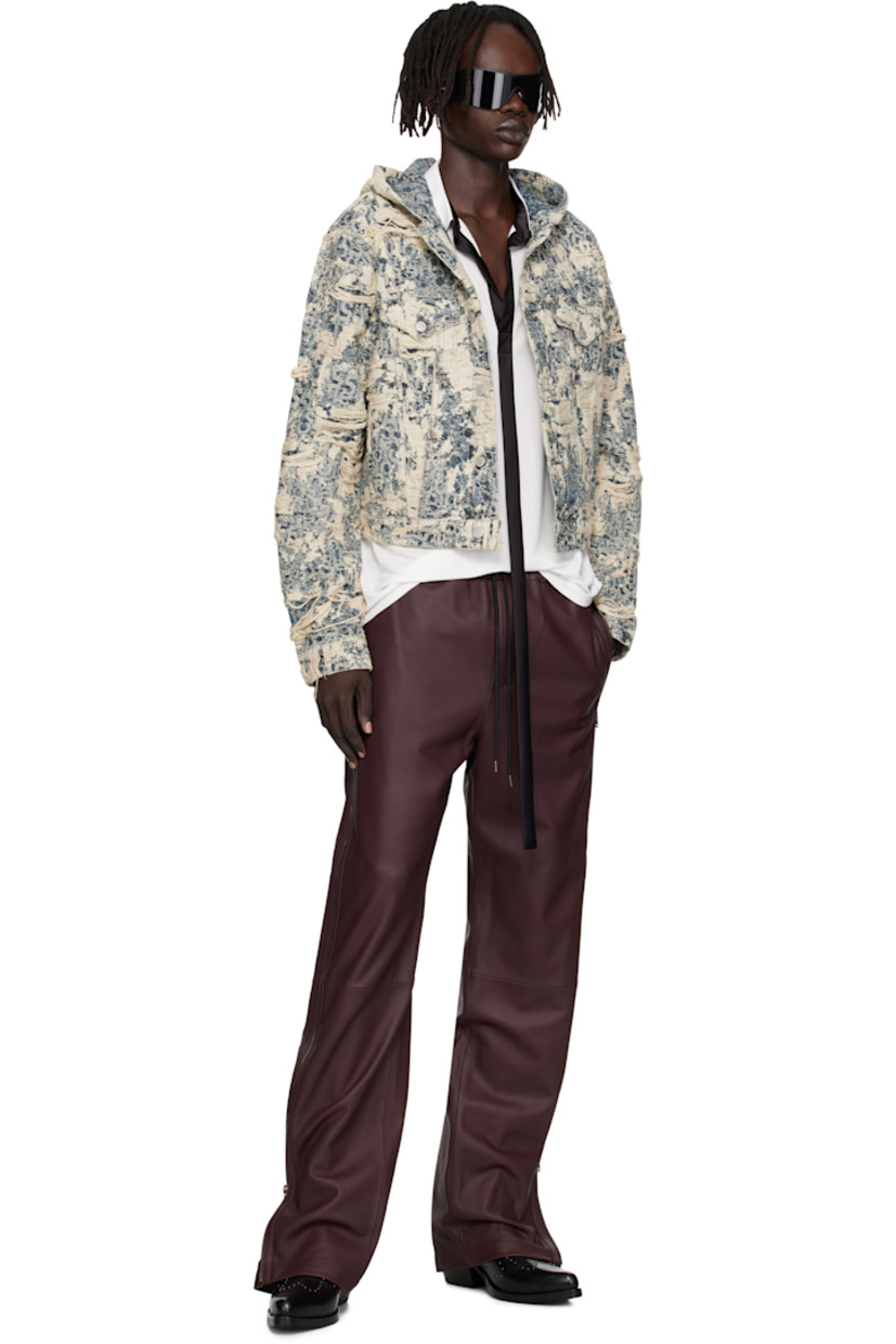 Non-stretch organic cotton denim jacket.

· Enzyme-washed
· Distressing and jacquard logo pattern throughout
· Integrated hood
· Button closure
· Flap pockets at chest
· Welt pockets at waist
· Cropped hem
· Buttoned cuffs
· Adjustable button tabs at back hem
· Logo-engraved silver-tone hardware

Supplier color: Mid blue