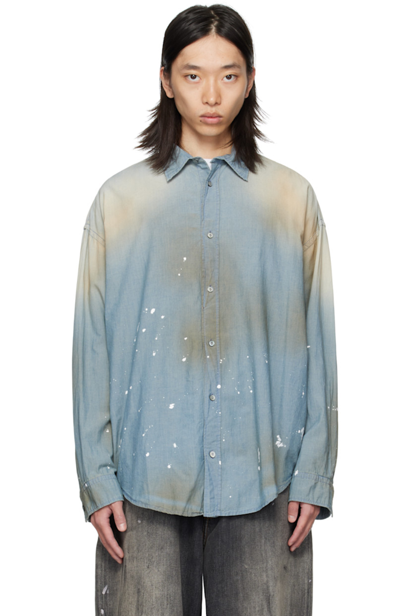 Cotton chambray shirt. 

· Discoloration and paint splatter throughout 
· Spread collar 
· Button closure
· Shirttail hem
· Dropped shoulders
· Buttoned barrel cuffs
· Logo printed and twin pleats at back yoke 

Supplier color: Light blue