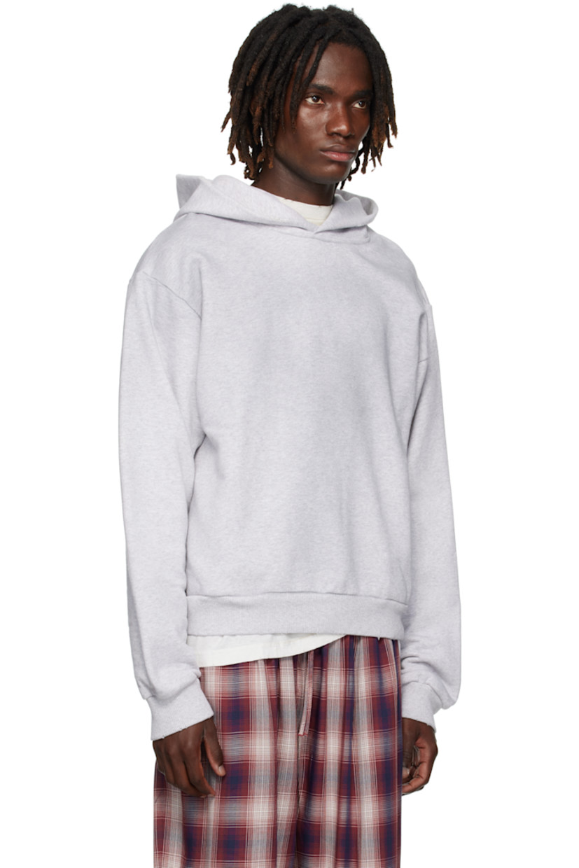 Organic cotton- and recycled polyester-blend French terry hoodie.

· Distressing throughout
· Seam pockets at waist
· Rib-knit hem and cuffs
· Dropped shoulders
· Logo printed at back

Supplier color: Pale grey melange