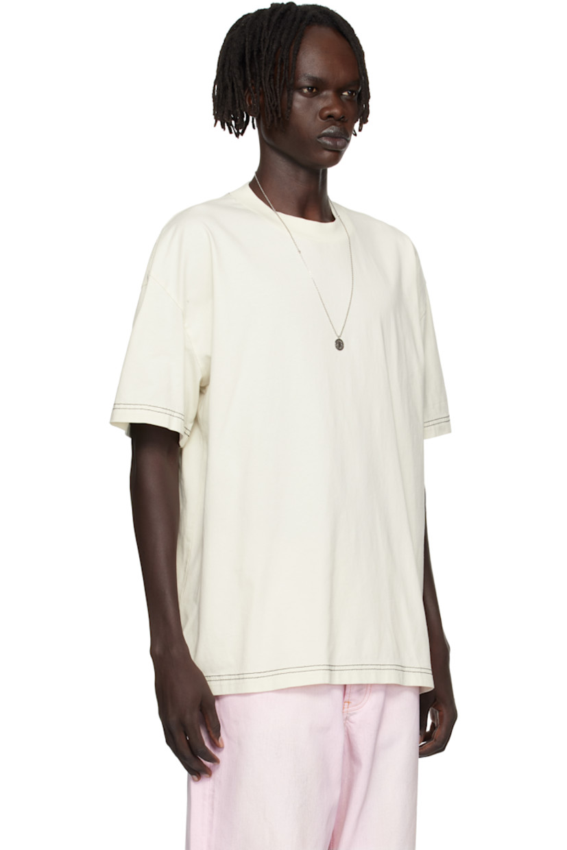 Organic cotton jersey T-shirt.

· Rib-knit crewneck
· Dropped shoulders
· Logo embroidered at back
· Contrast stitching in black

Supplier color: Off white