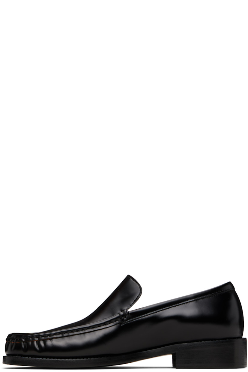 Polished calfskin loafers.

· Gathering at moc toe
· Mismatched logo stamp at vamp
· Grained lambskin lining
· Stacked leather heel with rubber injection
· Calfskin sole
· Heel: H1.25"

Supplier color: Black