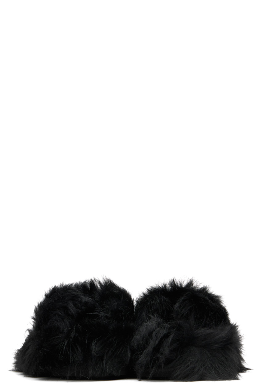 Lambskin shearling flip-flop-style sandals.

· Open toe
· Thong-style strap at vamp
· Logo embossed at padded footbed
· Rubber sole

Supplier color: Black