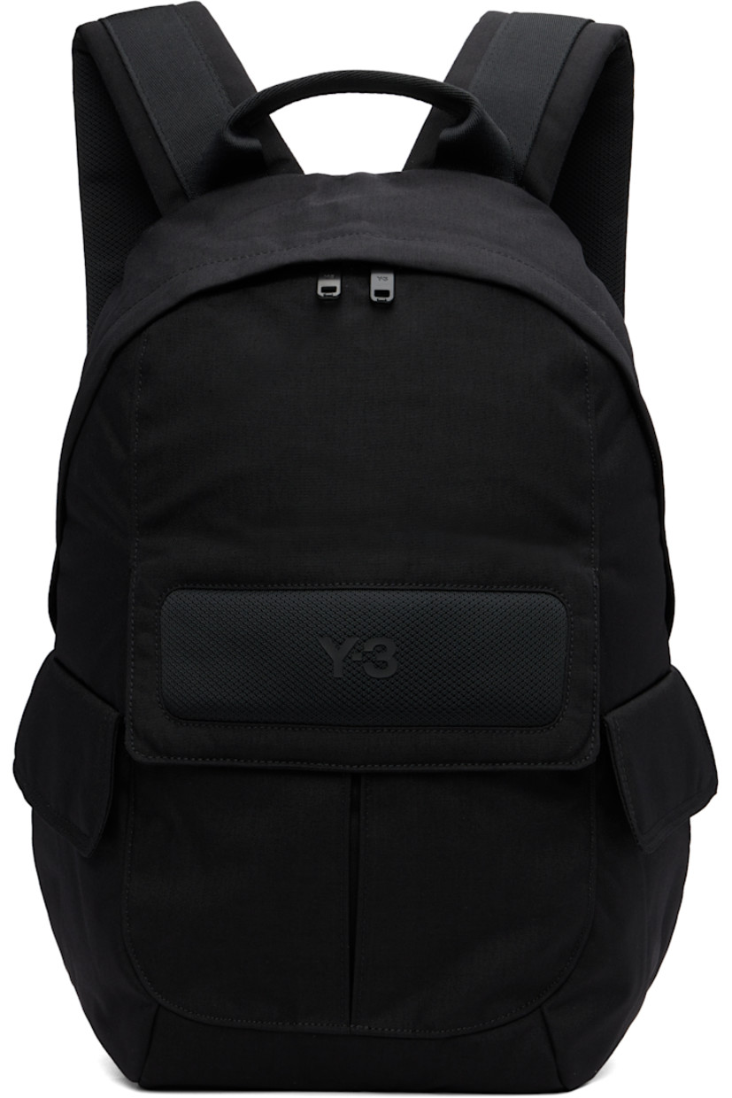 Nylon canvas and mesh backpack. 

· Rolled carry handle
· Adjustable padded shoulder straps
· Bonded logo and patch pocket at side
· Flap pocket at sides
· Padded back face 
· Two-way zip closure
· D-ring, zip pocket, and laptop compartment 
· Twill lining
· H17" x W12" x D5" / 35 L 

Supplier color: Black