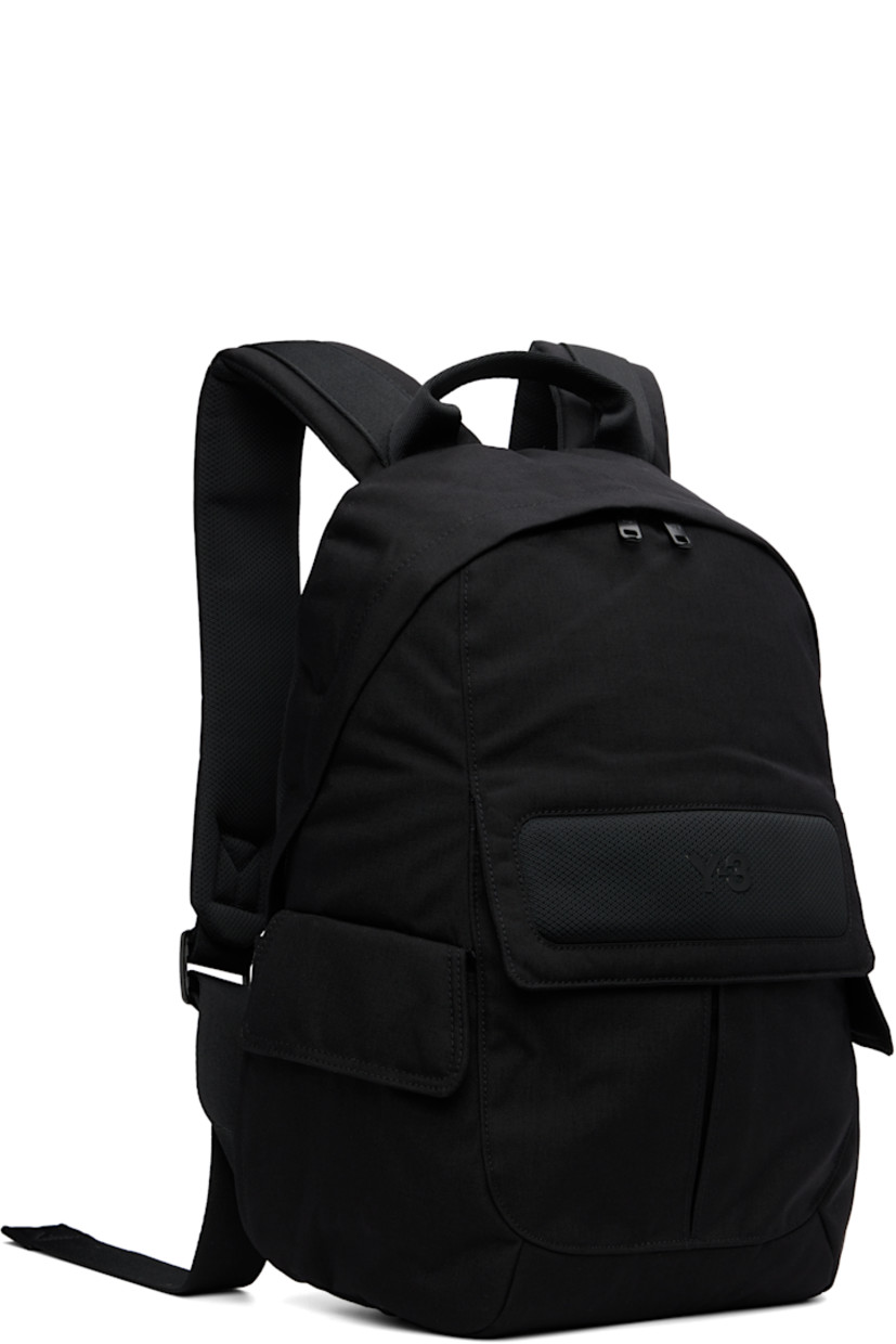 Nylon canvas and mesh backpack. 

· Rolled carry handle
· Adjustable padded shoulder straps
· Bonded logo and patch pocket at side
· Flap pocket at sides
· Padded back face 
· Two-way zip closure
· D-ring, zip pocket, and laptop compartment 
· Twill lining
· H17" x W12" x D5" / 35 L 

Supplier color: Black