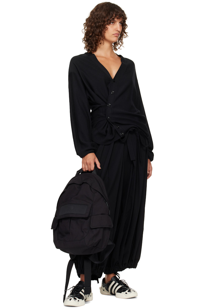 Nylon canvas and mesh backpack. 

· Rolled carry handle
· Adjustable padded shoulder straps
· Bonded logo and patch pocket at side
· Flap pocket at sides
· Padded back face 
· Two-way zip closure
· D-ring, zip pocket, and laptop compartment 
· Twill lining
· H17" x W12" x D5" / 35 L 

Supplier color: Black