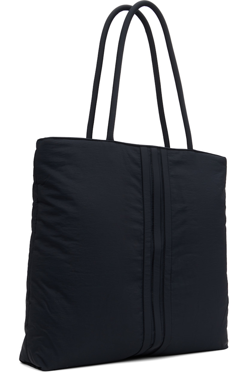 Padded recycled nylon-blend taffeta tote. 

· Twin rolled shoulder straps
· Embroidered logo at face
· Signature stripes at face and back
· Zip closure
· D-ring and zip pocket at interior 
· Twill lining
· Logo-engraved hardware
· H17" x W17" x D3.5"/ 40 L 

Supplier color: Black
