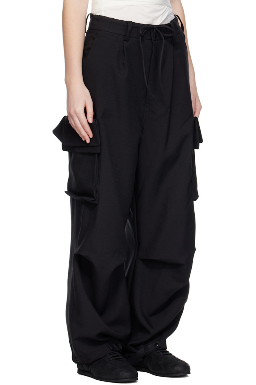 Recycled polyester twill cargo pants.

· Drawstring and belt loops at waistband
· Four-pocket styling
· Zip fly
· Pleats at front
· Darts at knees
· Adjustable press-stud strap at cuffs
· Flap and patch pockets at outseams
· Logo bonded at pocket

Supplier color: Black