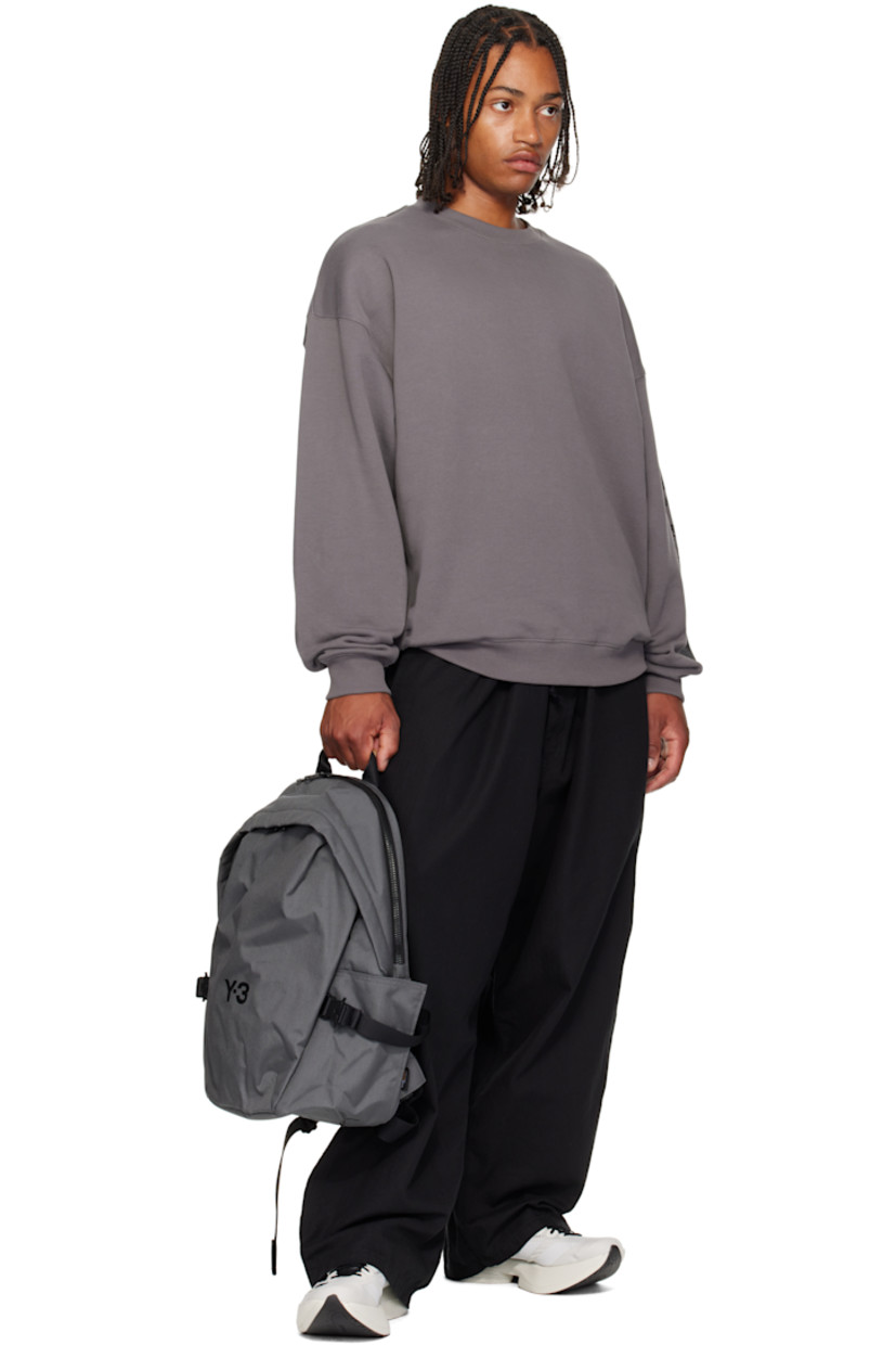 CORDURA® nylon canvas backpack. Zip compartment at base with detachable waterproof bag cover.

· Webbing carry handle
· D-ring at adjustable padded shoulder straps
· Sternum strap
· Zip pocket at face
· Logo bonded at face and shoulder strap
· Pockets with rollercoaster cinch buckles at sides
· Padded mesh back face
· Two-way zip closure
· Padded laptop compartment and patch pocket
· Satin twill lining
· H17.75" x W13" x D7.5" / 35 L

Supplier color: Granit