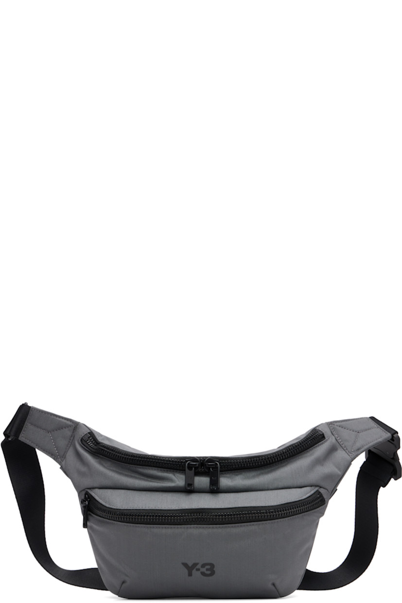 Padded CORDURA® nylon canvas belt bag.

· Adjustable crossbody strap
· Zip pocket at face
· Logo bonded at face
· Logo flag at outer side
· Zip closure
· Zip pocket at interior
· Satin twill lining
· H7" x W11" x D3.75"

Supplier color: Granite
