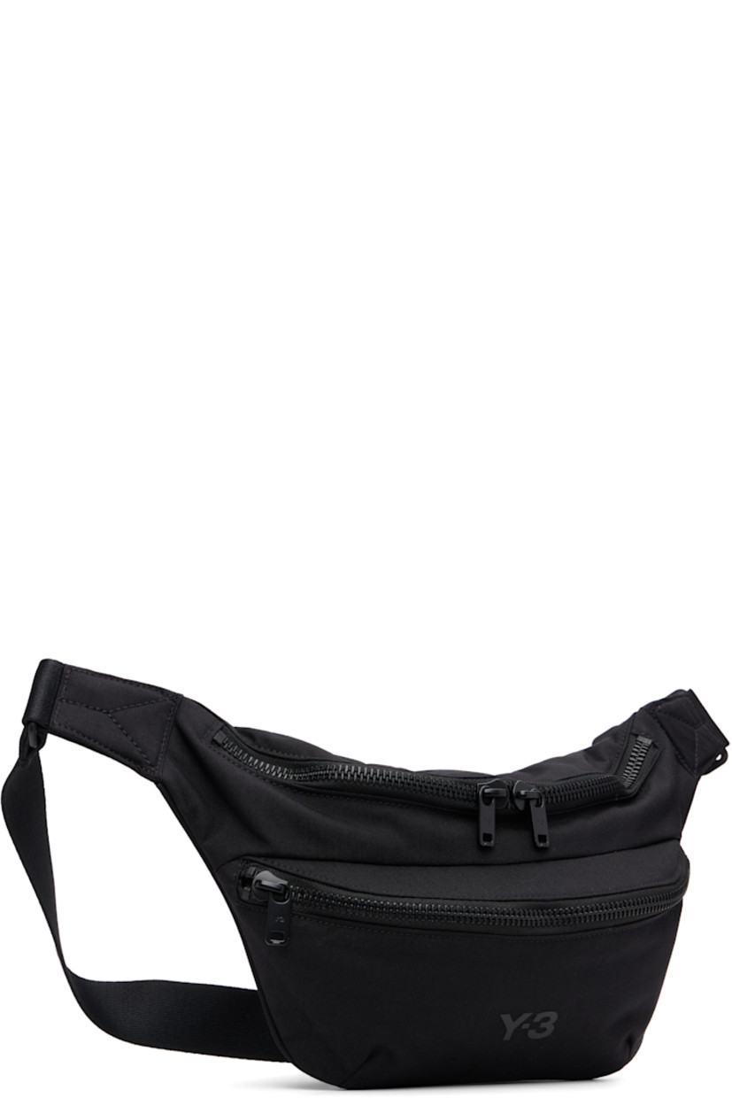 Padded CORDURA® nylon canvas belt bag.

· Adjustable crossbody strap
· Zip pocket at face
· Logo bonded at face
· Logo flag at outer side
· Zip closure
· Zip pocket at interior
· Satin twill lining
· H7" x W11" x D3.75"

Supplier color: Black