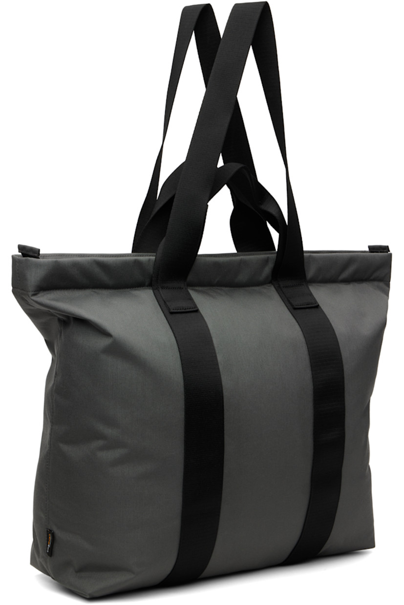 Canvas tote.

· Fixed carry handles and shoulder straps
· Bonded logo and press-release straps at face
· Two-way zip closure
· D-ring and zip pocket at interior
· Laptop compartment
· Twill lining
· H18" x W21" x D6"

Supplier color: Granit