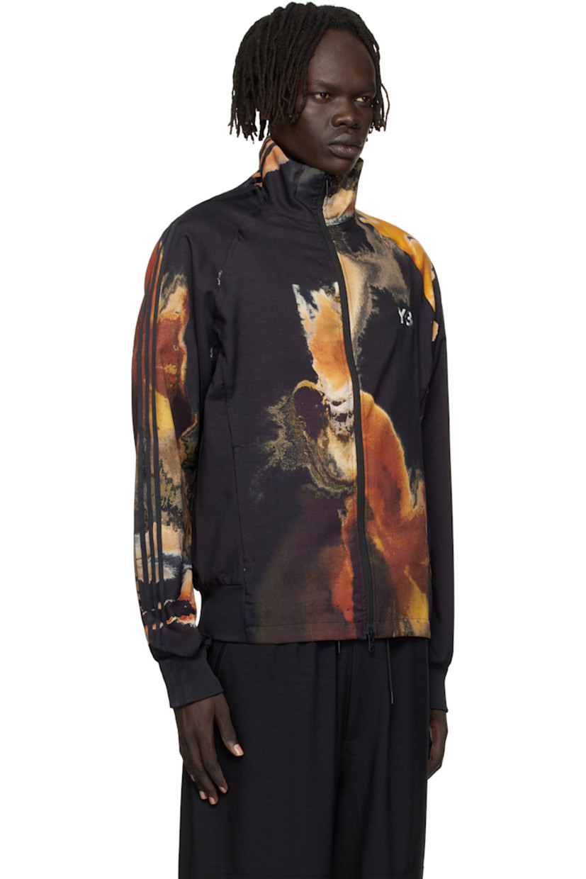 Recycled polyester twill track jacket.

· Graphics printed throughout 
· Stand collar 
· Two-way zip closure
· Bonded logo at chest
· Seam pockets at waist
· Rib-knit hem and cuffs
· Stripes at sleeve 
· Raglan sleeves

Supplier color: Black