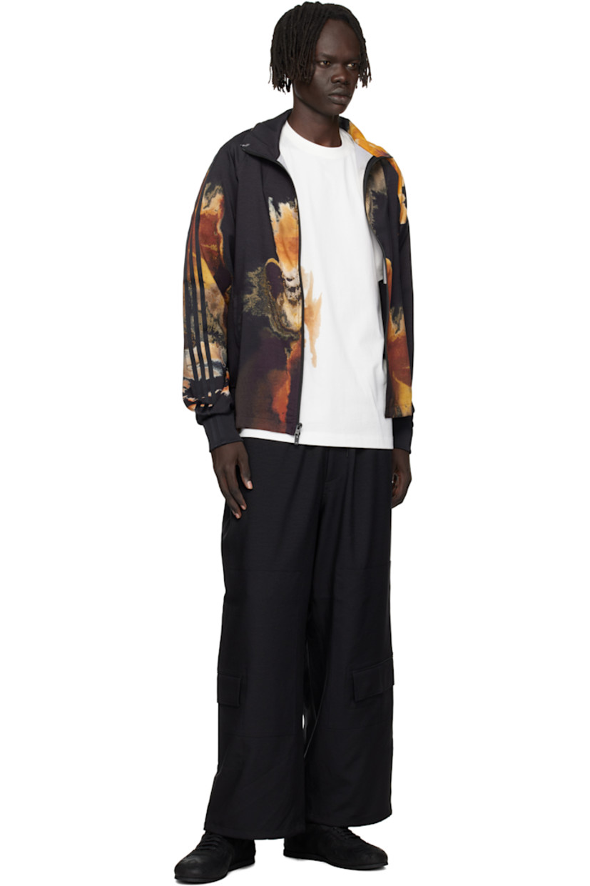 Recycled polyester twill track jacket.

· Graphics printed throughout 
· Stand collar 
· Two-way zip closure
· Bonded logo at chest
· Seam pockets at waist
· Rib-knit hem and cuffs
· Stripes at sleeve 
· Raglan sleeves

Supplier color: Black