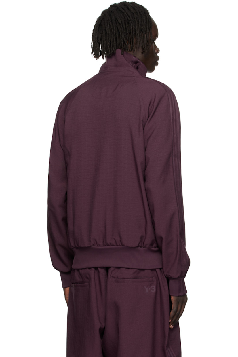 Recycled polyester twill track jacket. 

· Stand collar 
· Two-way zip closure
· Logo bonded at chest
· Zip pockets at front
· Rib-knit hem and cuffs
· Raglan sleeves
· Stripe appliqués at sleeve

Supplier color: Shadow maroon