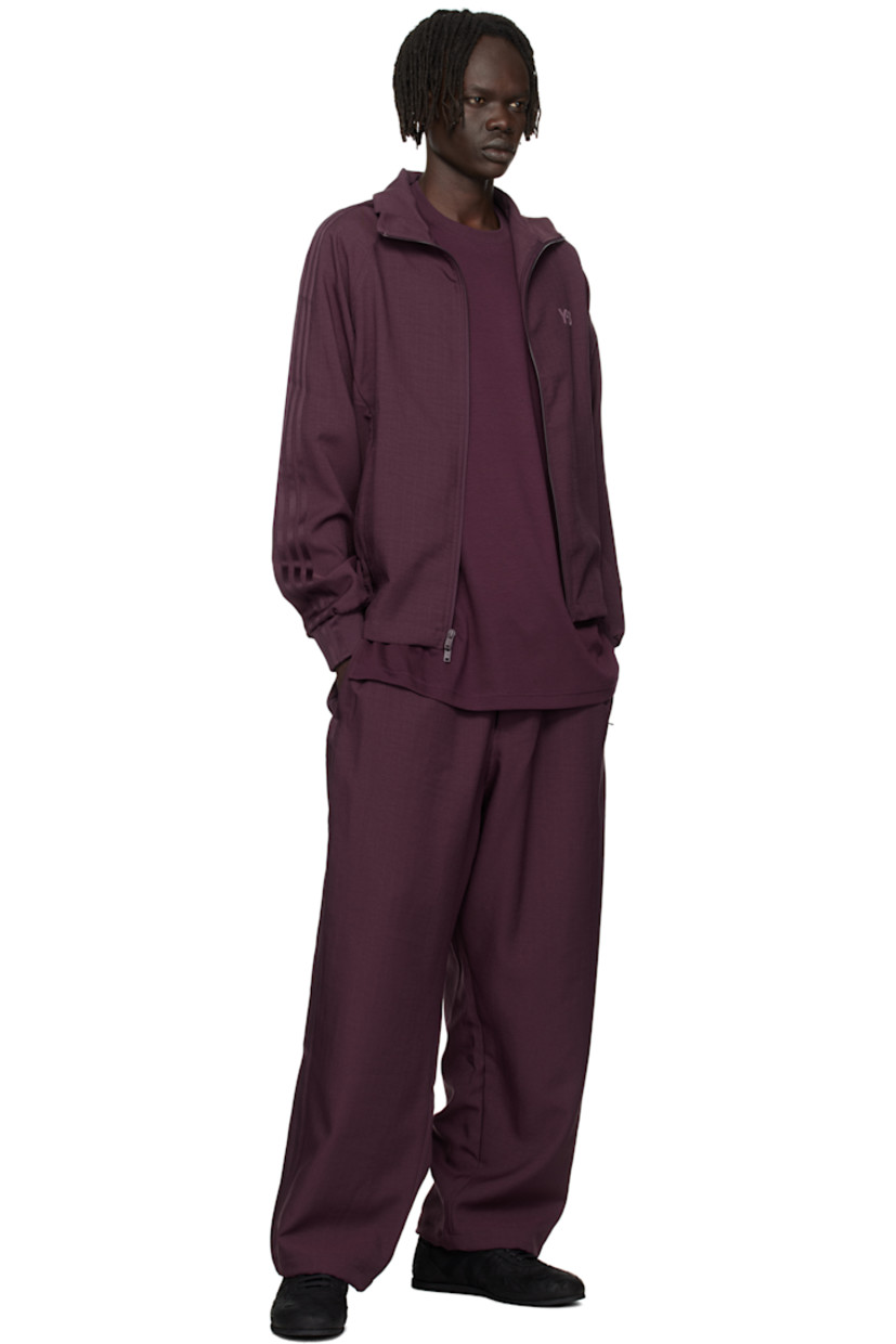 Recycled polyester twill track jacket. 

· Stand collar 
· Two-way zip closure
· Logo bonded at chest
· Zip pockets at front
· Rib-knit hem and cuffs
· Raglan sleeves
· Stripe appliqués at sleeve

Supplier color: Shadow maroon