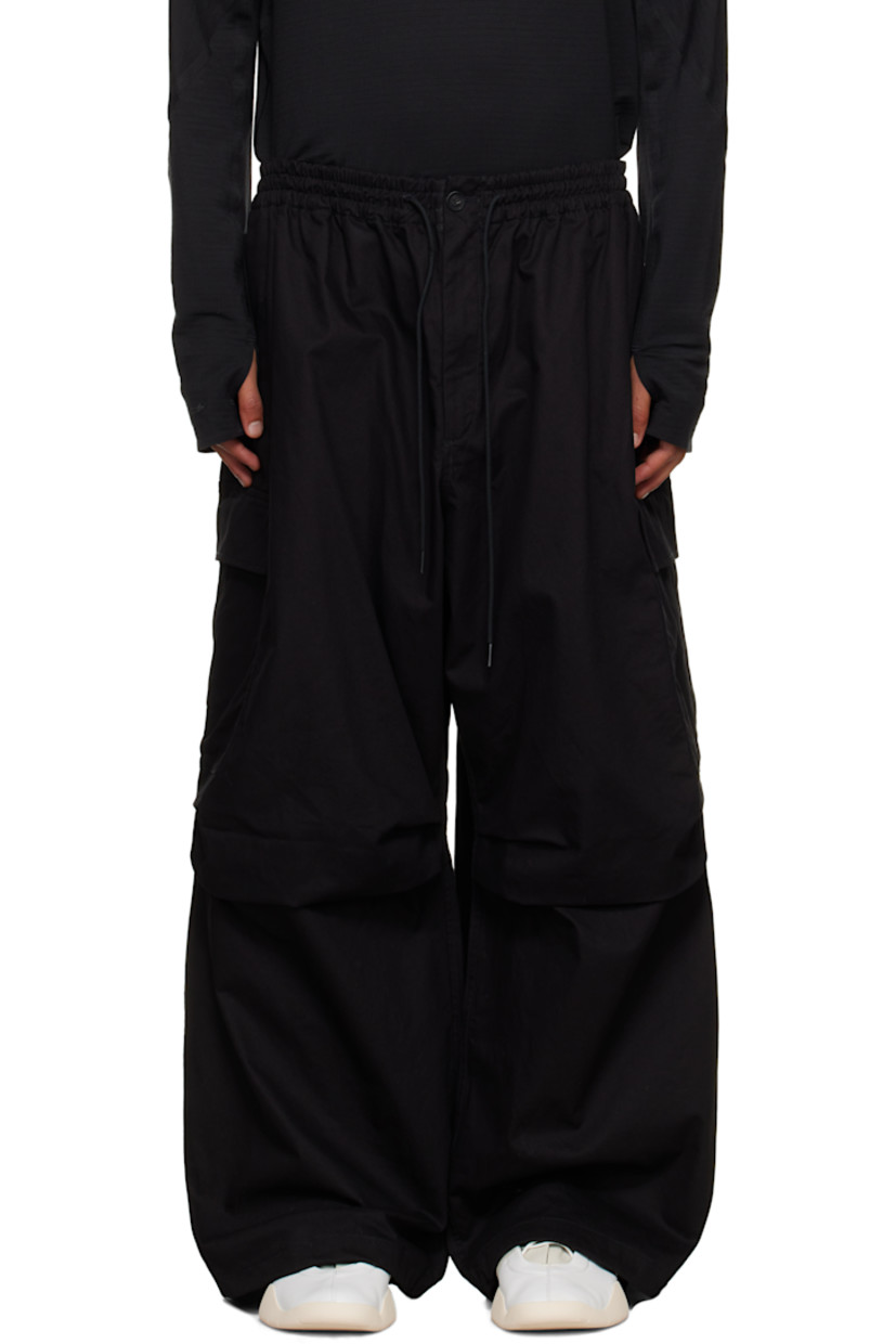 Cotton- and hemp-blend twill cargo pants.

· Loose-fit 
· Drawstring at elasticized waistband
· Four-pocket styling
· Zip fly 
· Pleat at knees 
· Drawstring at cuffs
· Cargo pocket at outseams
· Logo bonded at cargo pocket
· Horn hardware 

Supplier color: Black