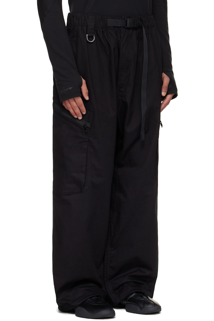Cotton-blend twill cargo pants.

· Integrated press-release belt at elasticized waistband
· Belt loops
· Four-pocket styling
· Zip fly
· D-ring at front waistband
· Bungee-style drawstring at cuffs
· Welt pocket at outseam
· Zip pocket at outseams

Supplier color: Black