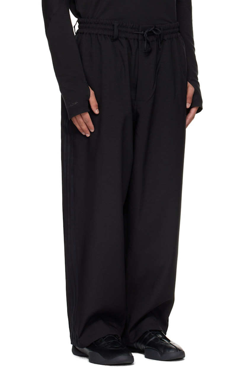 Recycled twill track pants.

· Belt loops and drawstring at elasticized waistband
· Four-pocket styling
· Zip fly
· Bungee-style drawstring at cuffs
· Stripe appliqués at outseams

Supplier color: Black