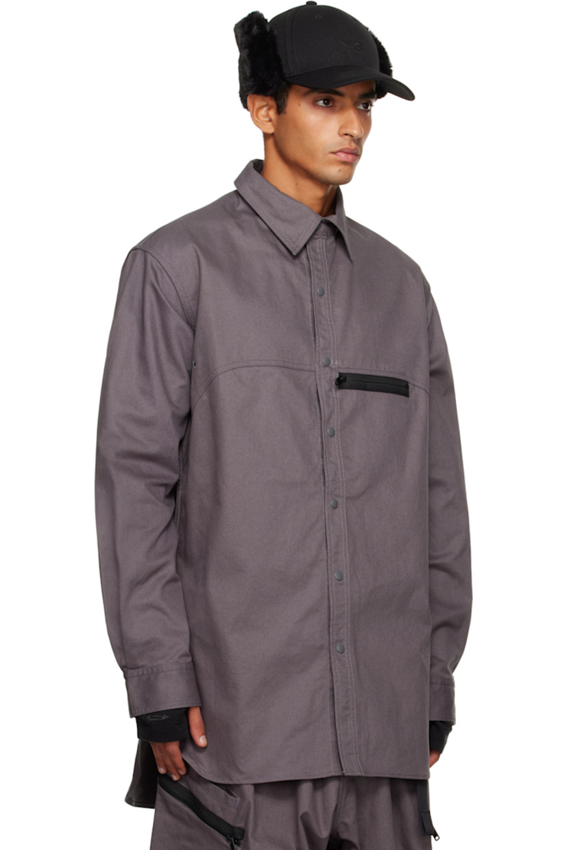 Cotton- and hemp-blend twill shirt.

· Press-stud fastening at spread collar 
· Press-stud closure 
· Zip pocket at chest
· Embroidered eyelets at front and back
· Shirttail hem 
· Buttoned barrel cuffs
· Logo bonded at back collar 

Supplier color: Granit