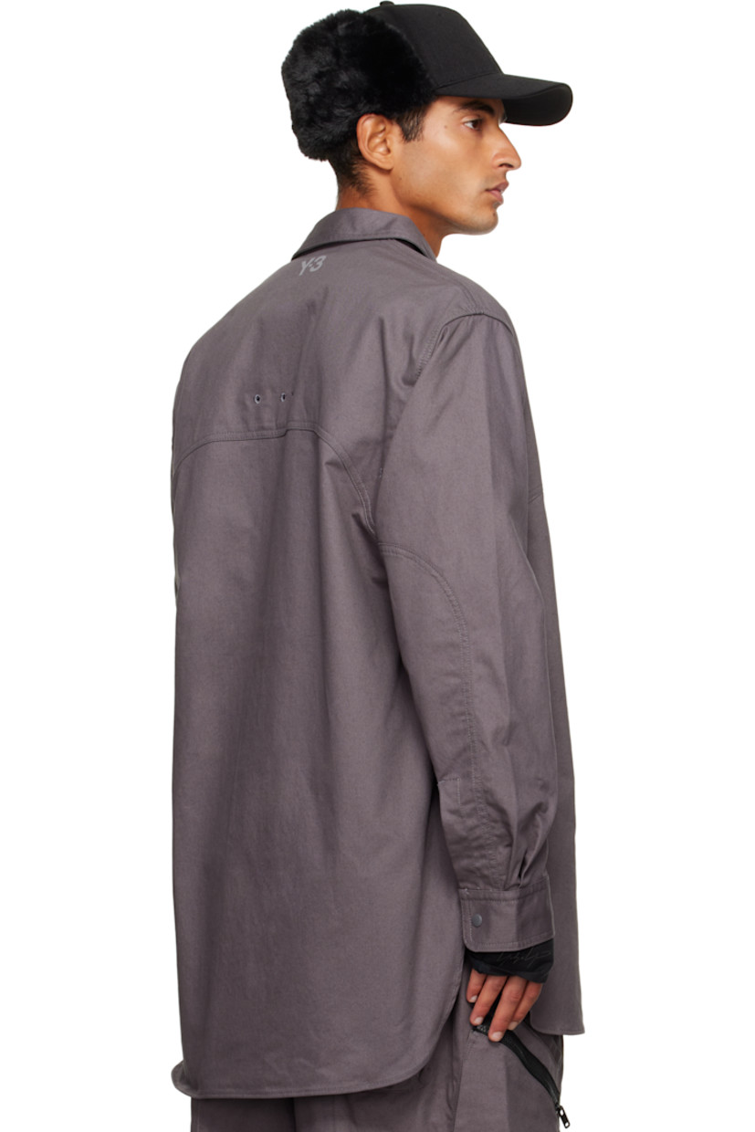 Cotton- and hemp-blend twill shirt.

· Press-stud fastening at spread collar 
· Press-stud closure 
· Zip pocket at chest
· Embroidered eyelets at front and back
· Shirttail hem 
· Buttoned barrel cuffs
· Logo bonded at back collar 

Supplier color: Granit