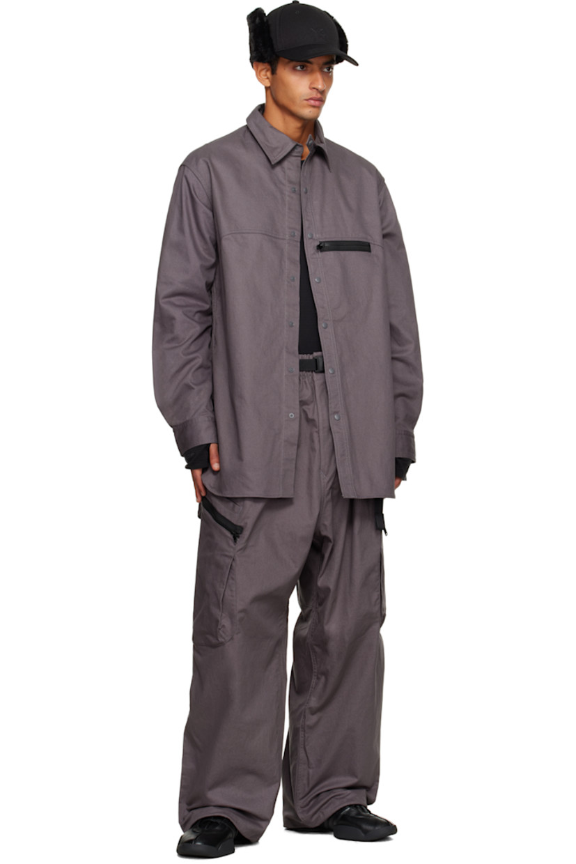 Cotton- and hemp-blend twill shirt.

· Press-stud fastening at spread collar 
· Press-stud closure 
· Zip pocket at chest
· Embroidered eyelets at front and back
· Shirttail hem 
· Buttoned barrel cuffs
· Logo bonded at back collar 

Supplier color: Granit