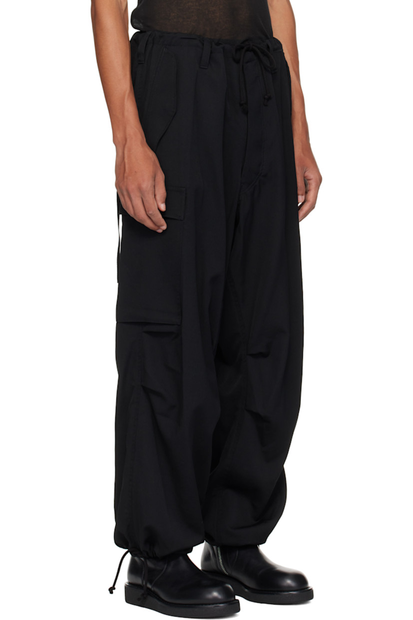 Wool gabardine cargo pants. 

· Drawstring at waistband 
· Belt loops
· Four-pocket styling
· Zip fly
· Tucks and pleat at knees
· Drawstring at cuffs
· Flap pocket at outseams

Supplier color: Black