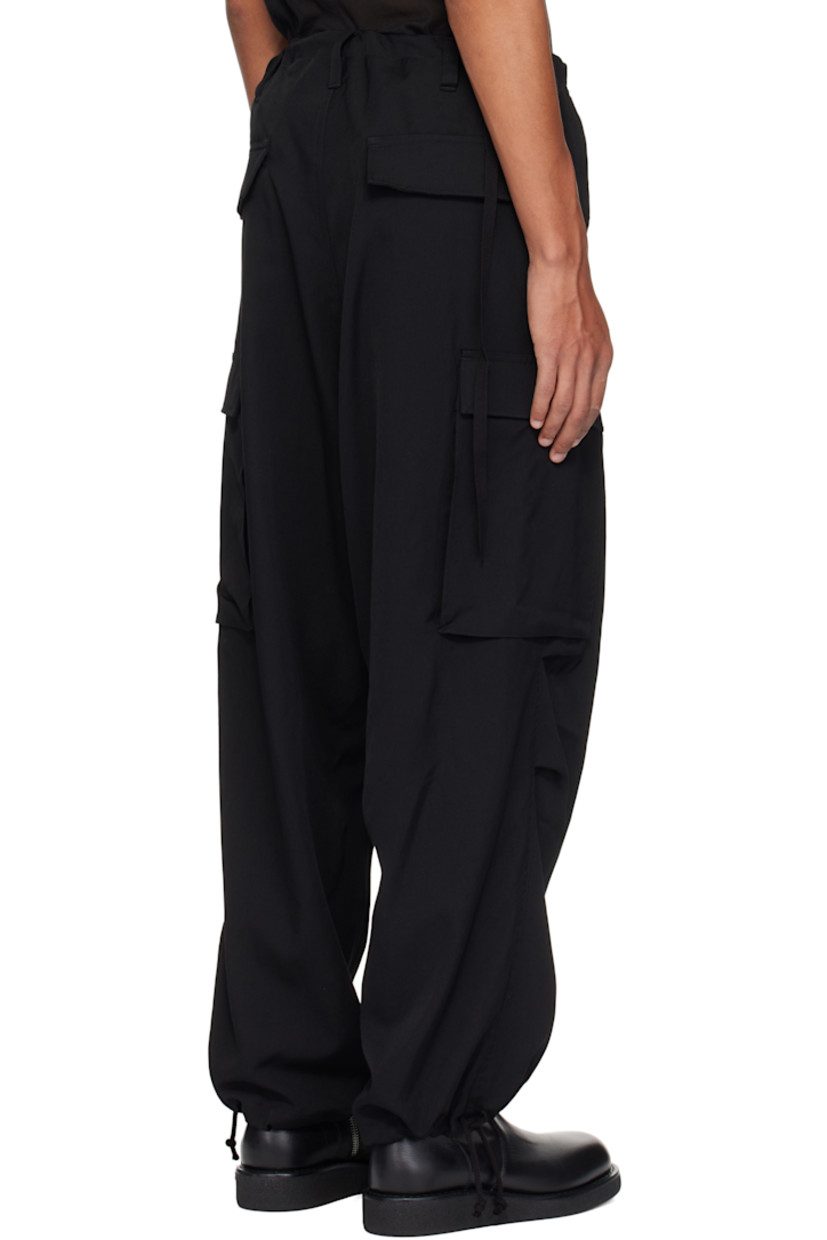 Wool gabardine cargo pants. 

· Drawstring at waistband 
· Belt loops
· Four-pocket styling
· Zip fly
· Tucks and pleat at knees
· Drawstring at cuffs
· Flap pocket at outseams

Supplier color: Black