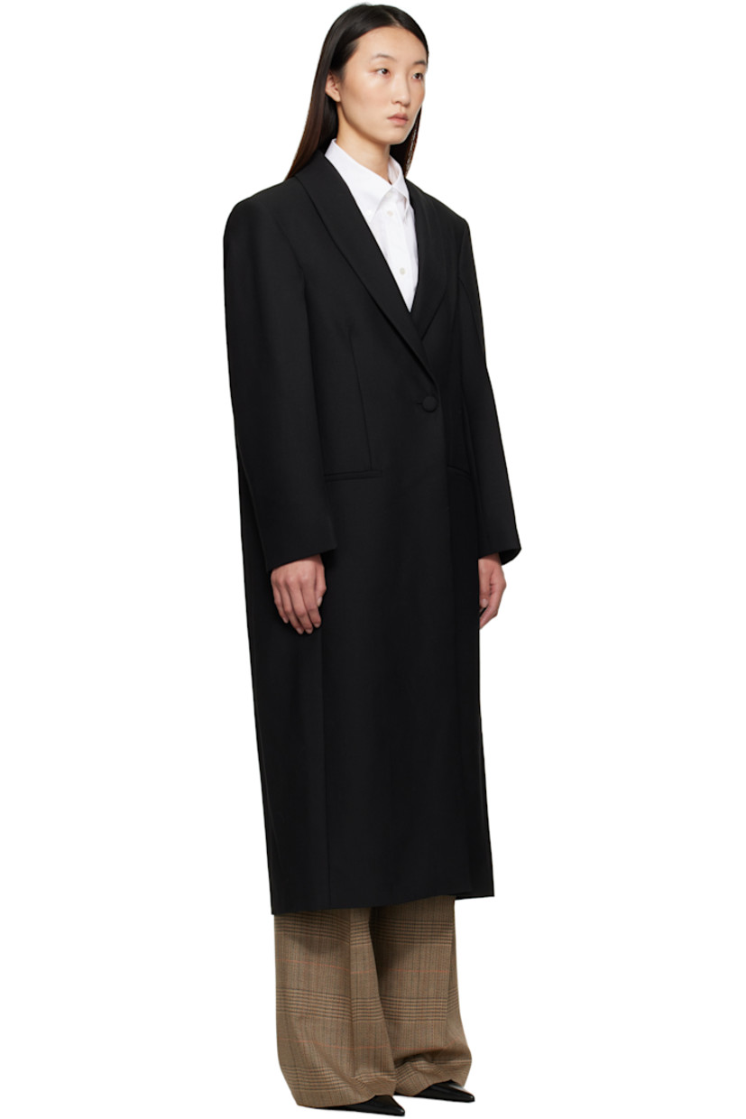 Virgin wool-blend grain de poudre coat.

· Shawl lapel
· Double-breasted button closure
· Welt pockets at front
· Padded shoulders
· Central vent at back hem
· Satin twill lining

Supplier color: Black
