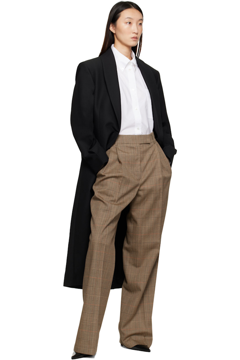 Virgin wool-blend grain de poudre coat.

· Shawl lapel
· Double-breasted button closure
· Welt pockets at front
· Padded shoulders
· Central vent at back hem
· Satin twill lining

Supplier color: Black