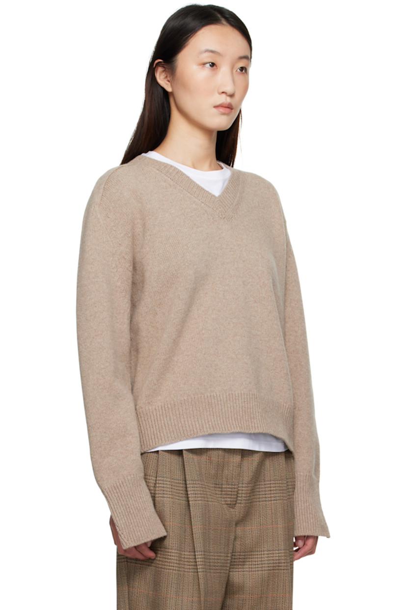 Knit wool- and cashmere-blend sweater.

· Rib-knit V-neck, hem, and vented cuffs
· Cutout at armscyes for alternate styling
· Saddle shoulders

Supplier color: Taupe melange