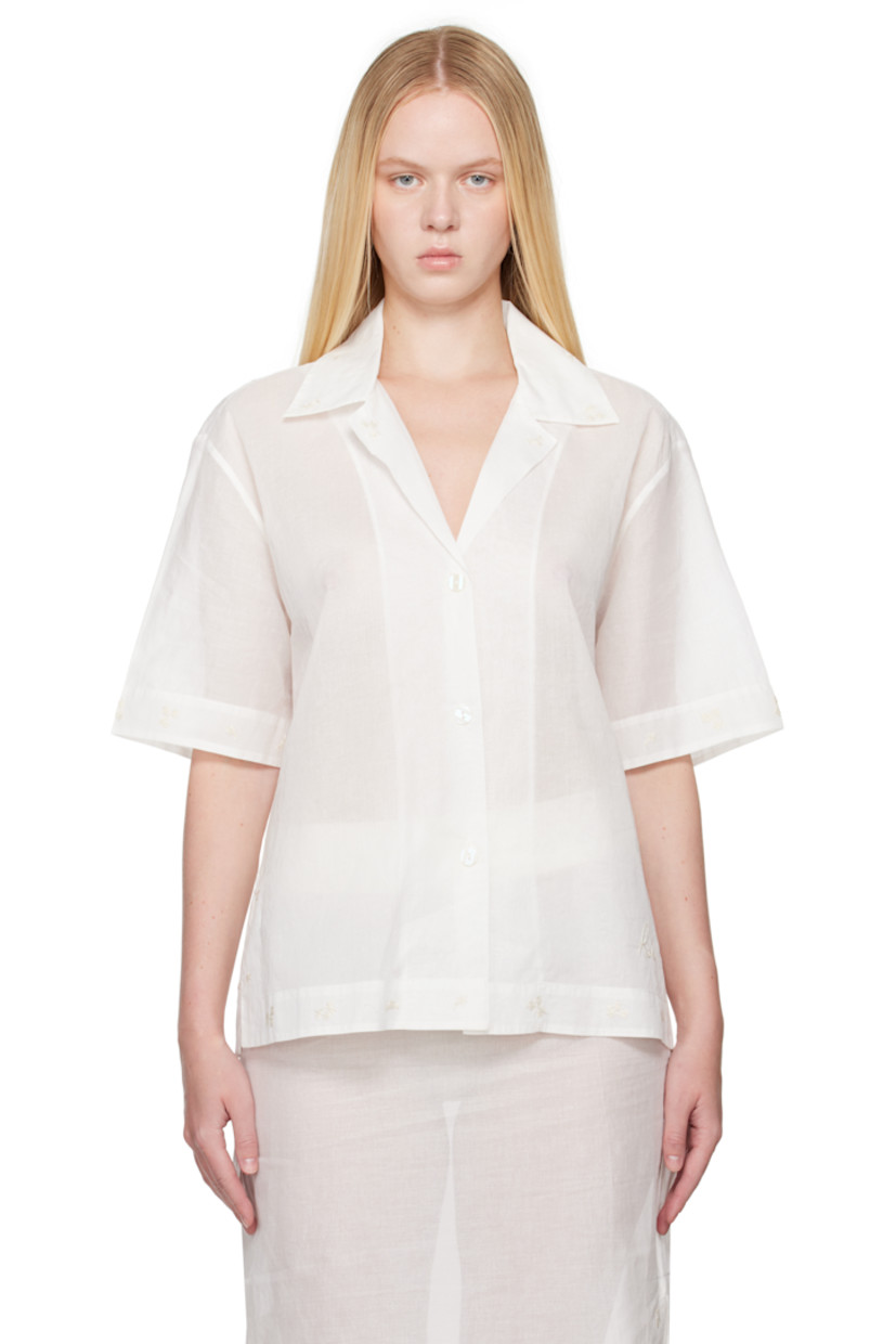 Semi-sheer cotton organza shirt. Embroidered floral pattern at collar, hem, and cuffs.

· Open spread collar
· Button closure
· Logo embroidered at front
· Vented side seams 
· Dropped shoulders

Supplier color: Off white