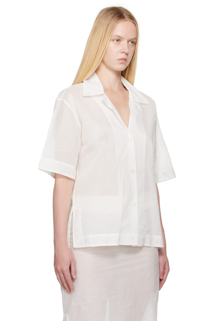 Semi-sheer cotton organza shirt. Embroidered floral pattern at collar, hem, and cuffs.

· Open spread collar
· Button closure
· Logo embroidered at front
· Vented side seams 
· Dropped shoulders

Supplier color: Off white