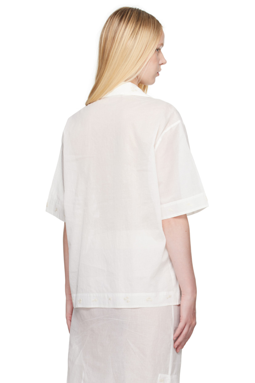 Semi-sheer cotton organza shirt. Embroidered floral pattern at collar, hem, and cuffs.

· Open spread collar
· Button closure
· Logo embroidered at front
· Vented side seams 
· Dropped shoulders

Supplier color: Off white