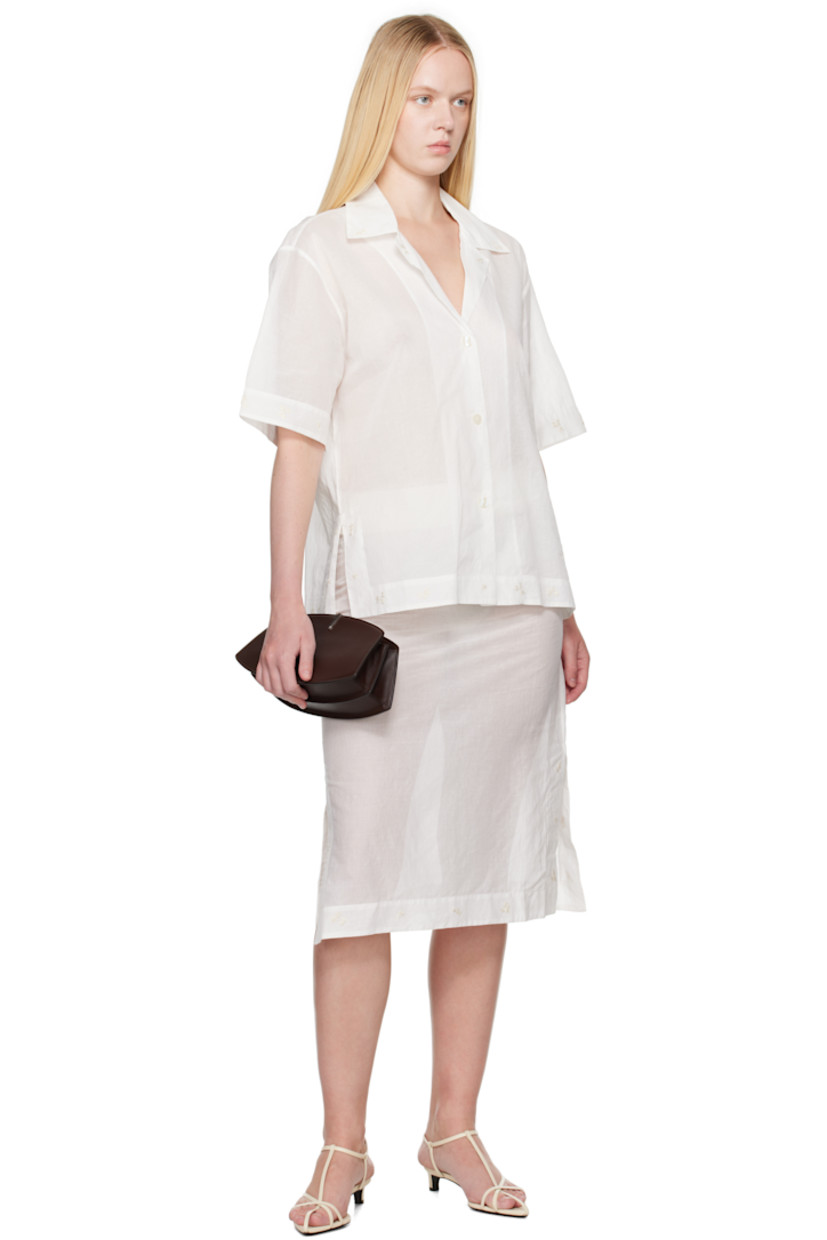 Semi-sheer cotton organza shirt. Embroidered floral pattern at collar, hem, and cuffs.

· Open spread collar
· Button closure
· Logo embroidered at front
· Vented side seams 
· Dropped shoulders

Supplier color: Off white