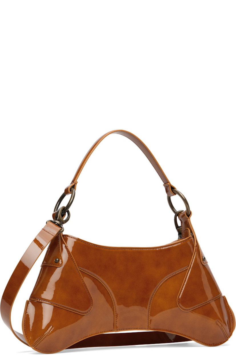 Handcrafted patent leather shoulder bag.

· Hand-painted edges throughout
· Fixed carry handle
· Detachable and adjustable crossbody strap
· Logo hardware at face
· Zip closure
· Viscose- and cotton-blend twill lining
· H8" x W14" x D2.5"

Supplier color: Rust