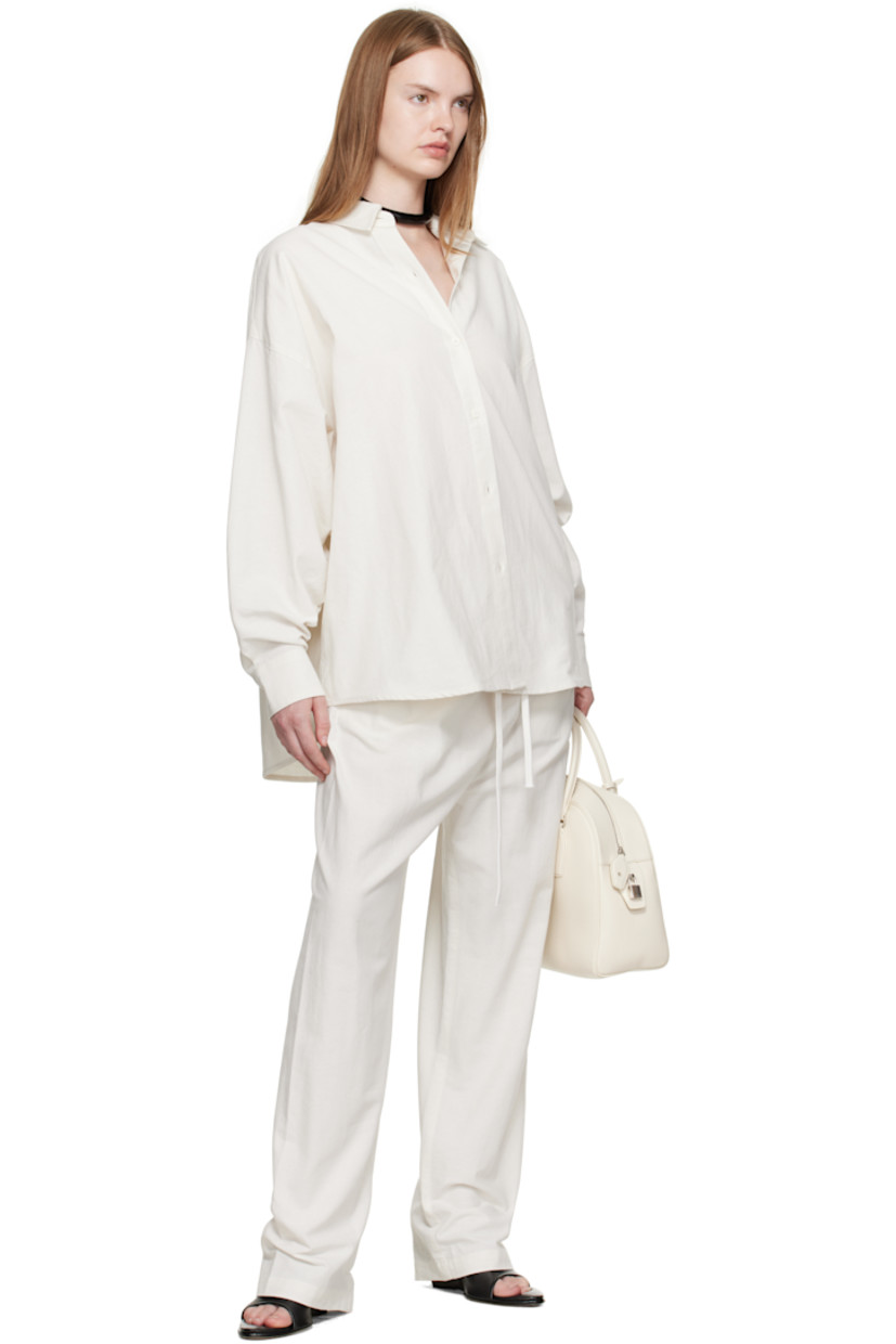 Cotton broadcloth lounge pants.

· Drawstring at elasticized waistband 
· Two-pocket styling
· Rubber logo patch at front waist

Supplier color: Cloud white