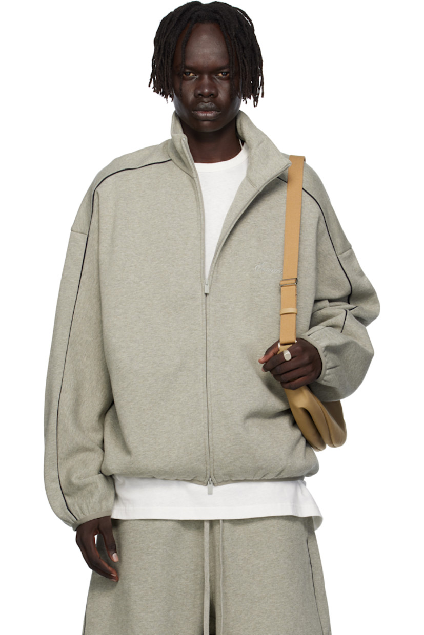 Cotton-blend fleece track jacket.

· Stand collar
· Two-way zip closure
· Logo embroidered at chest
· Seam pockets at waist
· Elasticized hem and cuffs
· Piping at sleeves
· Rubber logo patch at back collar

Supplier color: Concrete heather/Black piping