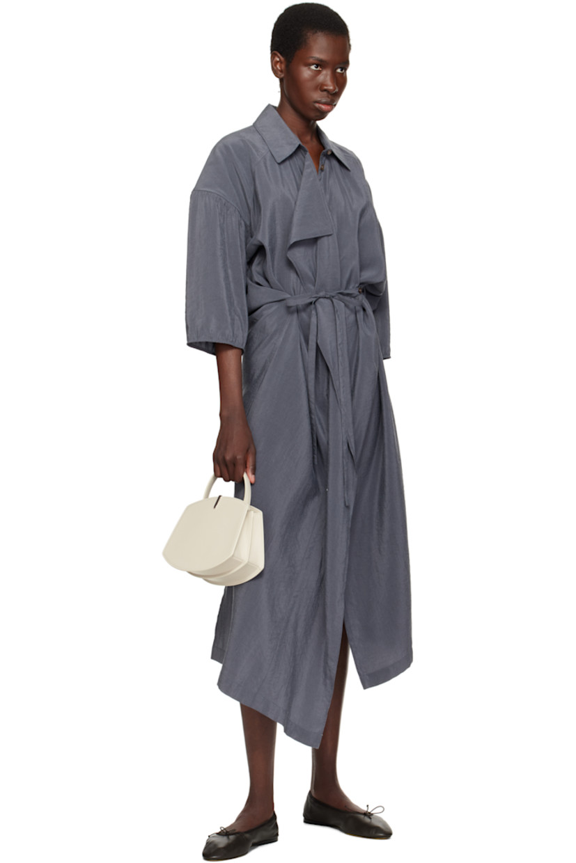 Structured buffed calfskin top handle bag in off-white.

· Carry handle at top
· Silver-tone hardware at face
· Accordion panel at sides
· Silver-tone logo stamp at back face
· Magnetic tab closure 
· Card slot at two compartment interior
· Buffed calfskin lining
· H6.75" x W8.25" x D4"

Supplier color: Ivory
