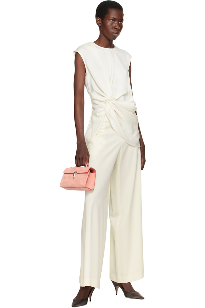 Calfskin suede top handle bag in pink.

· Fixed carry handle
· Turn-lock flap
· Card slot at interior
· Buffed calfskin lining
· Silver-tone hardware
· H5.5" x W8.5" x D3"

Supplier color: Camellia suede