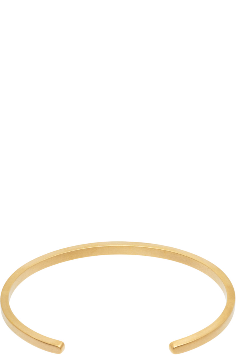 Open cuff bracelet in gold-tone sterling silver. Logo engraved at face.

Supplier color: Yellow gold plating burattato
