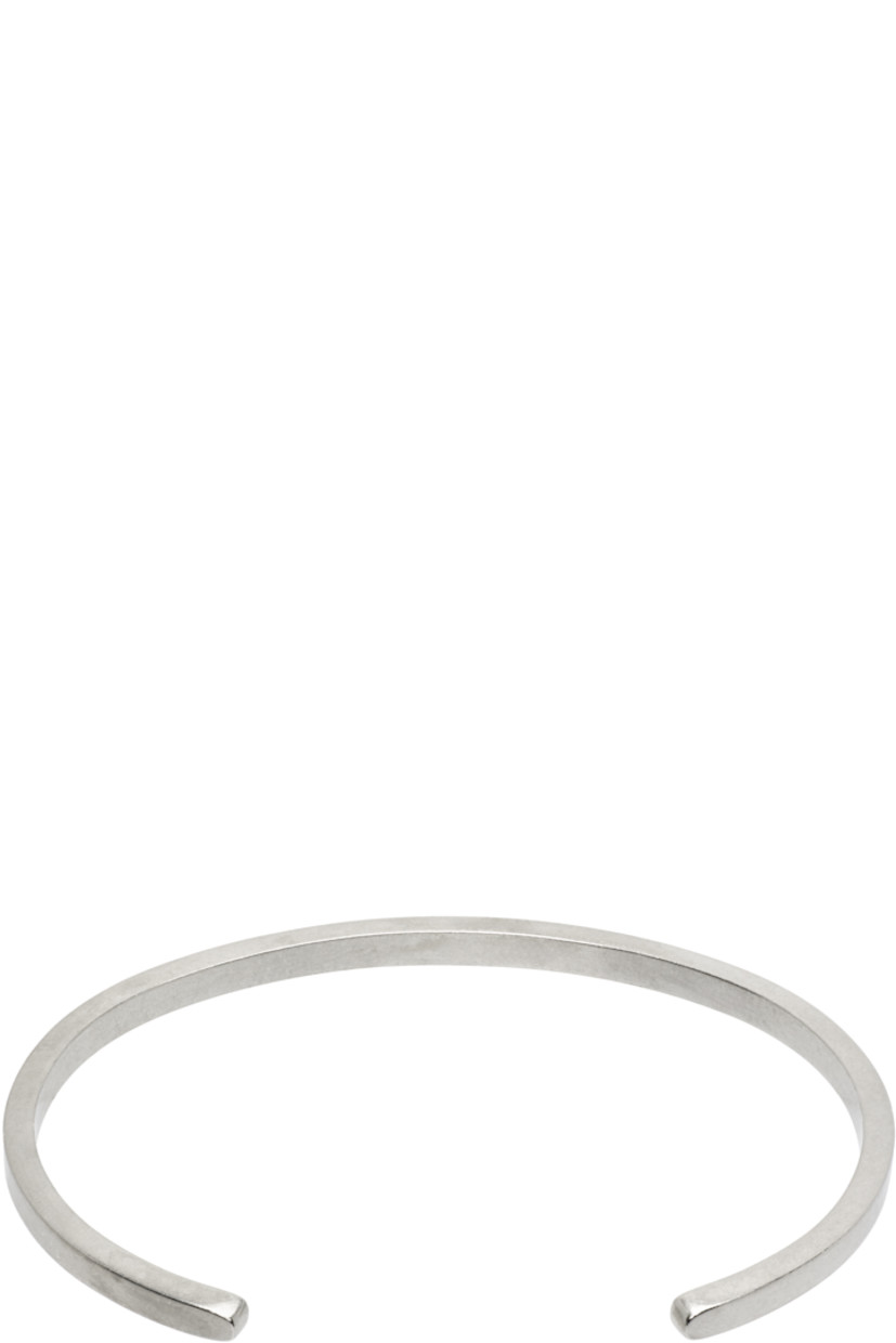 Open cuff bracelet in antiqued sterling silver. Logo engraved at face.

Supplier color: Palladio buratta