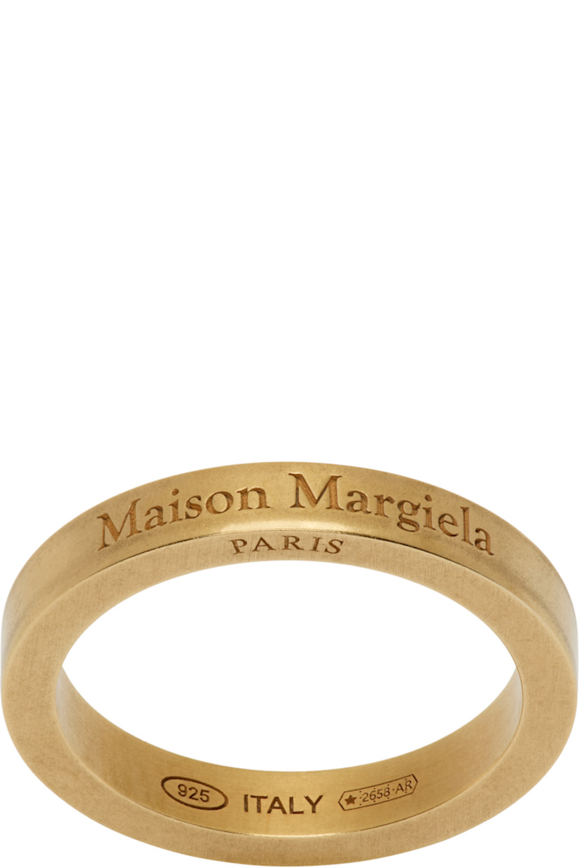 Band ring in gold-tone sterling silver.

· Logo engraved at face
· Hallmarking at inner band

Supplier color: Yellow gold plating