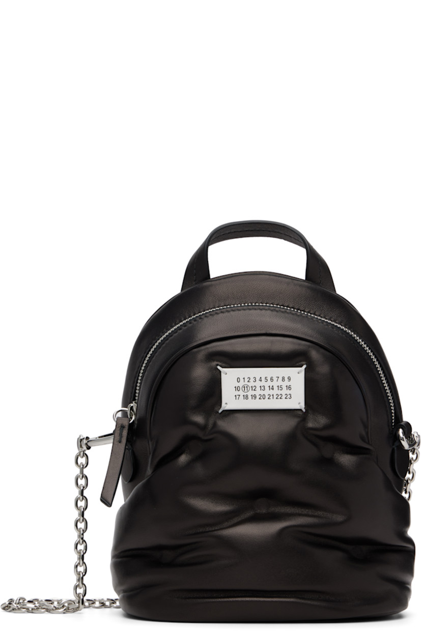 Buffed nappa lambskin backpack.

· Carry handle at top
· Detachable cable chain shoulder strap
· Logo patch at face
· D-ring and patch pocket at back face
· Zip closure
· Patch pocket at interior
· Silver-tone hardware
· H9” x W7.5” x D3.5”

Supplier color: Black