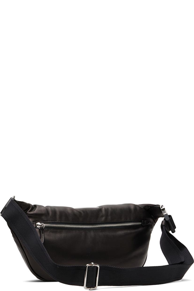 Grained sheepskin belt bag.

· Adjustable crossbody strap with buckle
· Logo patch and white stitching at top
· Tufting at face
· Zip compartment at back face
· Zip closure at main compartment
· Zip pocket at interior
· Satin lining
· H7" x W16" x D4.5"

Supplier color: Black