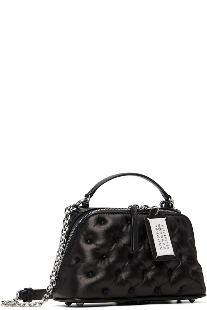 Tufted buffed sheepskin top handle bag.

· Fixed carry handle
· Detachable cable chain crossbody strap
· Bumper studs at base
· Logo tag at two-way zip closure
· Card slot at interior
· Woven lining
· H5" x W8.5" x D3"

Supplier color: Black
