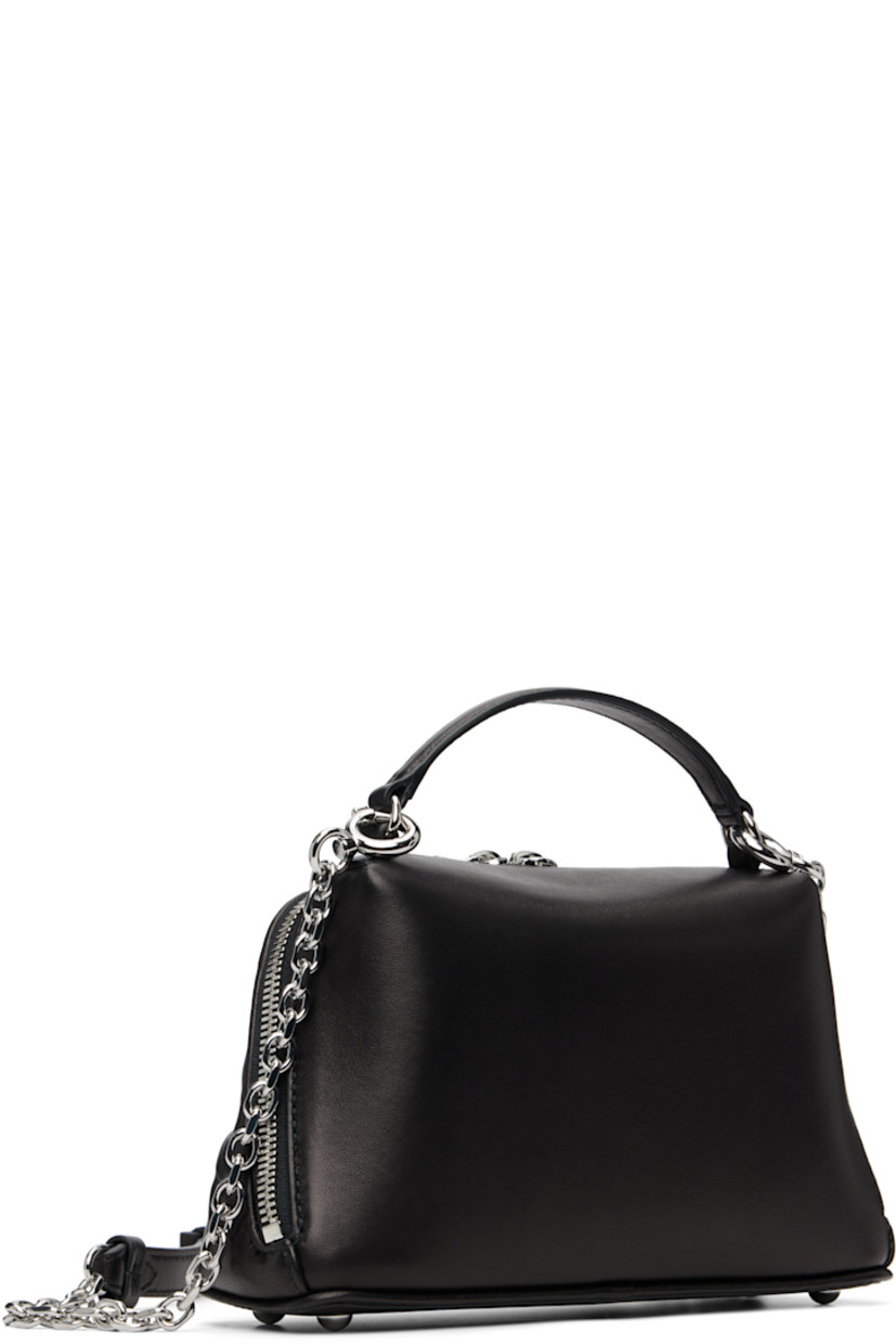 Tufted buffed sheepskin top handle bag.

· Fixed carry handle
· Detachable cable chain crossbody strap
· Bumper studs at base
· Logo tag at two-way zip closure
· Card slot at interior
· Woven lining
· H5" x W8.5" x D3"

Supplier color: Black