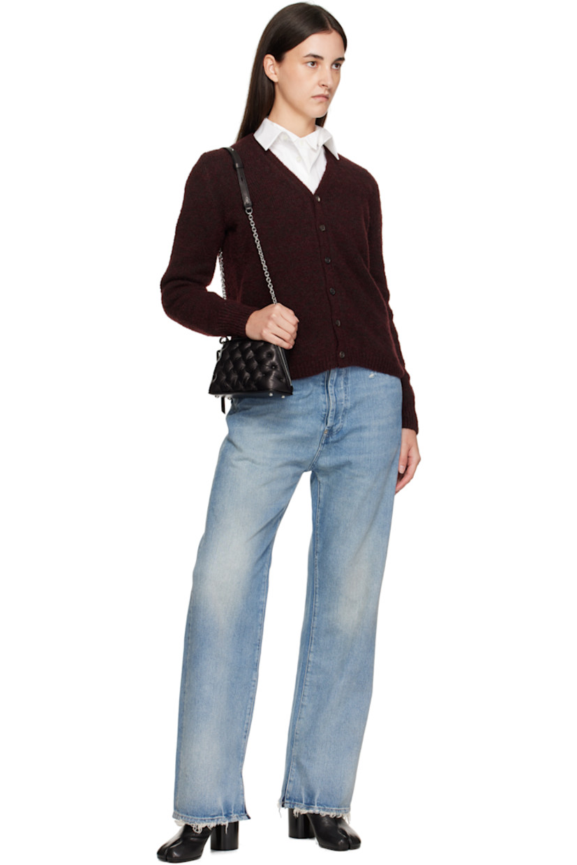 Tufted buffed sheepskin top handle bag.

· Fixed carry handle
· Detachable cable chain crossbody strap
· Bumper studs at base
· Logo tag at two-way zip closure
· Card slot at interior
· Woven lining
· H5" x W8.5" x D3"

Supplier color: Black