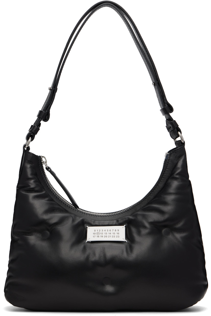 Buffed nappa lambskin shoulder bag.

· Adjustable shoulder strap
· Logo patch at face
· Zip closure
· Zip pocket at interior 
· Silver-tone hardware
· H8.5” x W10.5” x D3”

Supplier color: Black